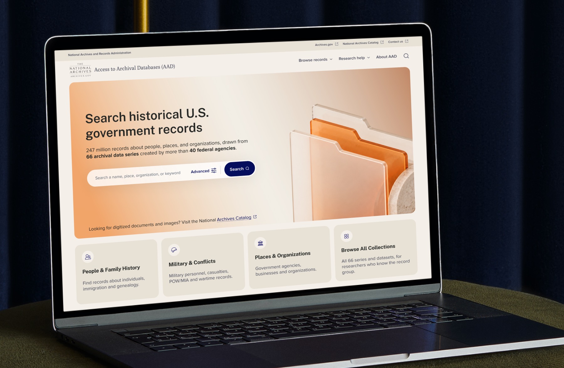 The redesigned Access to Archival Databases open on a laptop. A warm hero panel reads “Search historical U.S. government records” above a line stating 247 million records drawn from 66 archival data series created by more than 40 federal agencies, then a single wide search field with an Advanced option and a Search button. Four cards sit below — People and Family History, Military and Conflicts, Places and Organizations, and Browse All Collections.