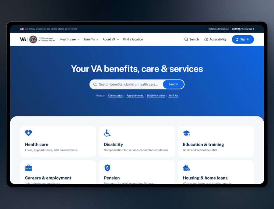 The redesigned VA.gov homepage — a deep blue page with one centred search field, four popular task links, and a grid of benefit cards.